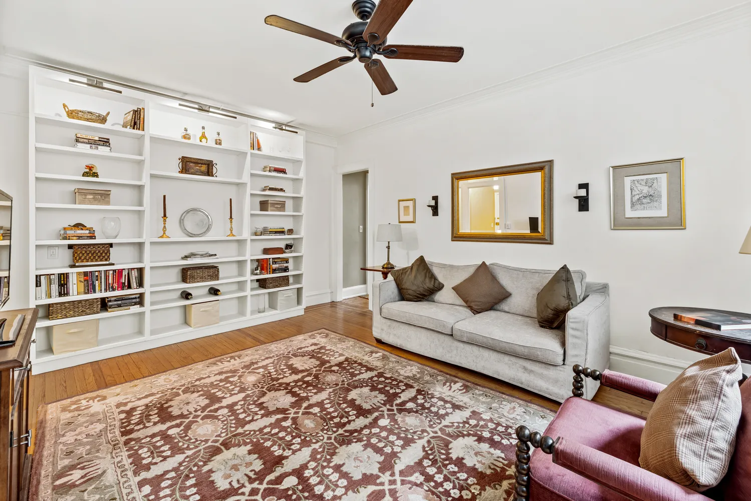 a living room with furniture and a book shelf