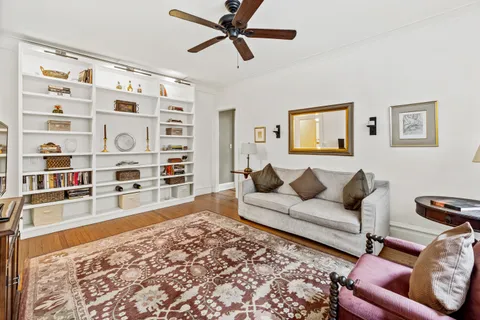a living room with furniture and a book shelf
