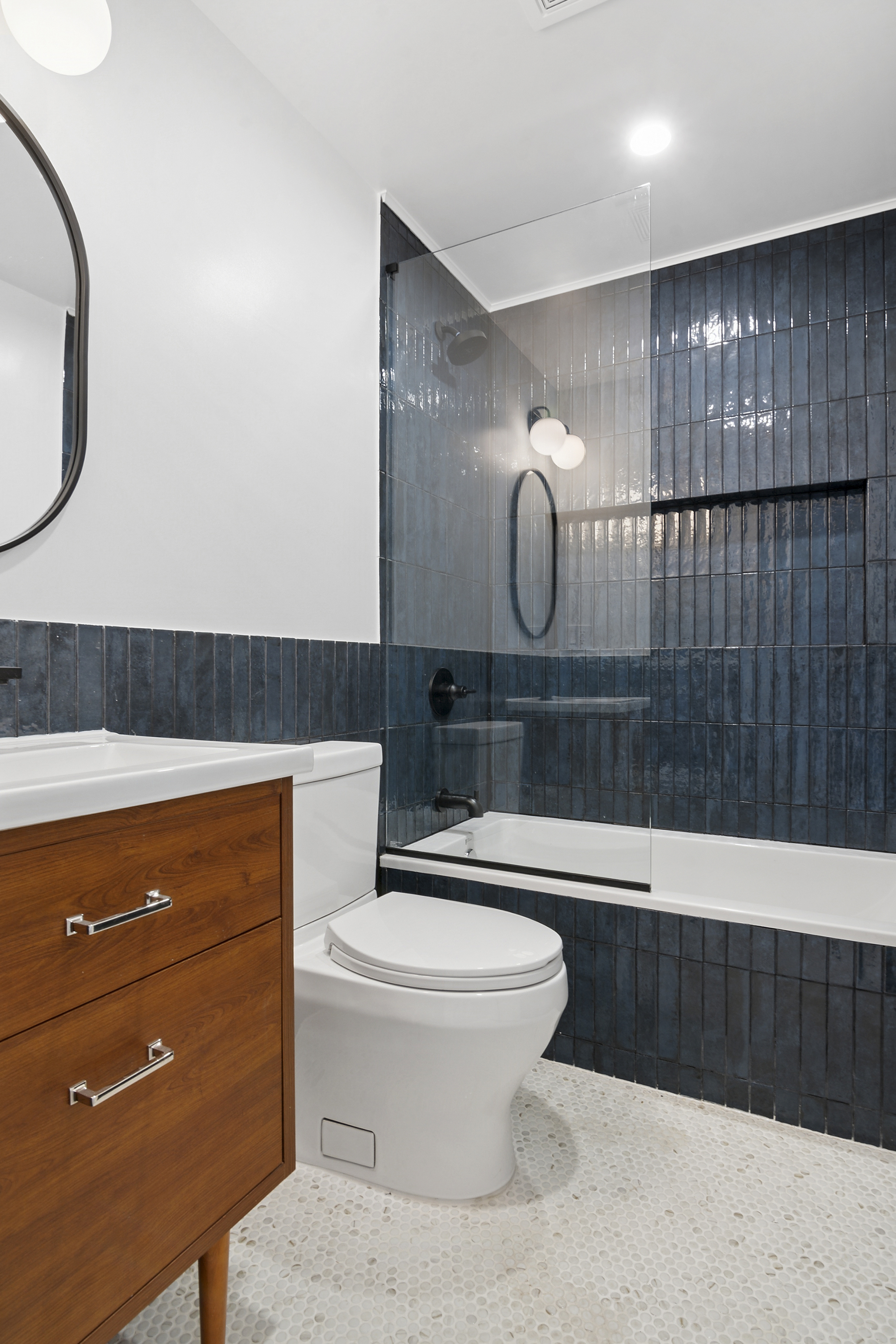 716 Decatur Street, Unit 1 Brooklyn, NY 11233 - Photo 3 of 7 a bathroom with a sink a toilet and a mirror