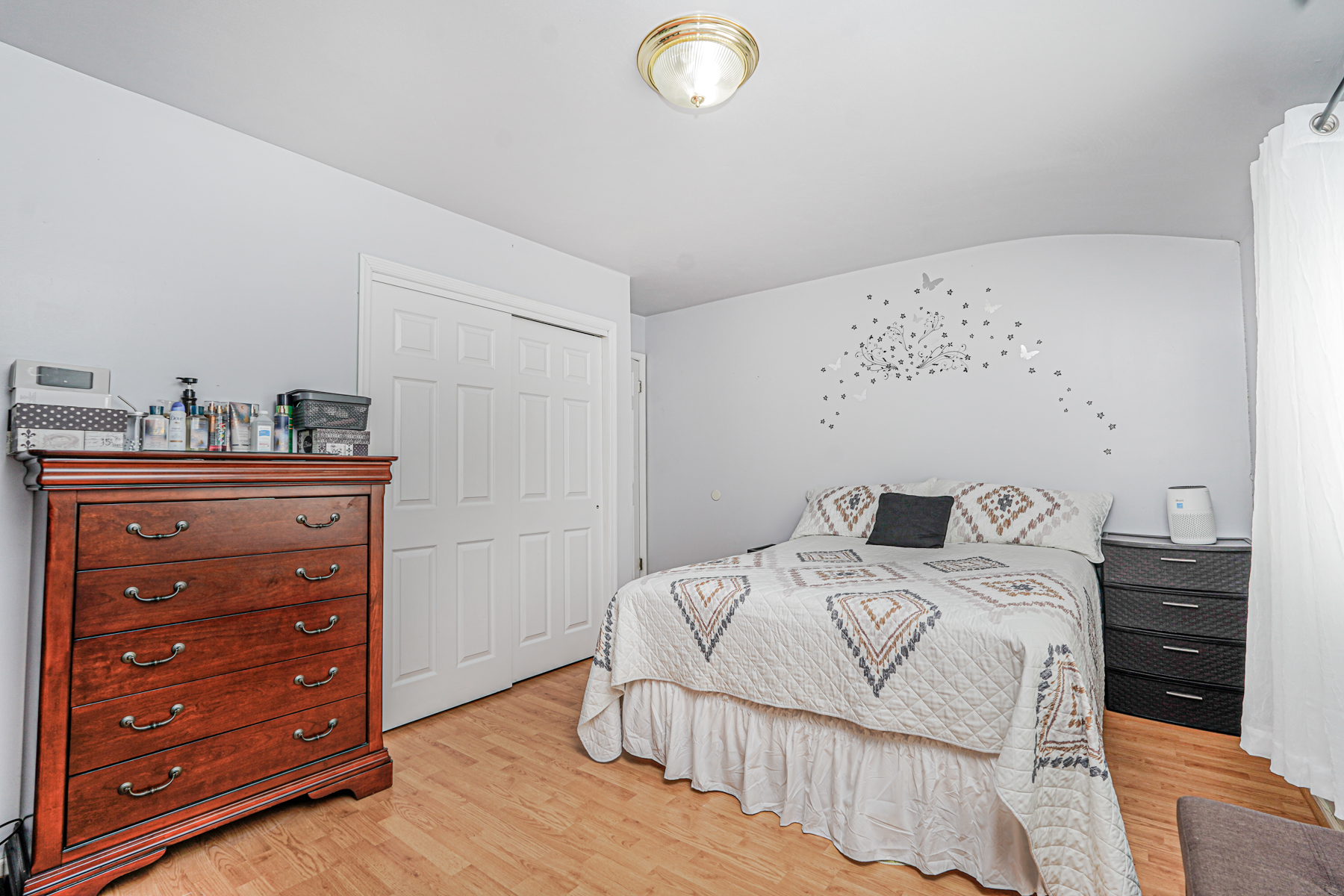 287 Greaves Avenue Staten Island, NY 10308 - Photo 21 of 35 a bedroom with a bed and a dresser