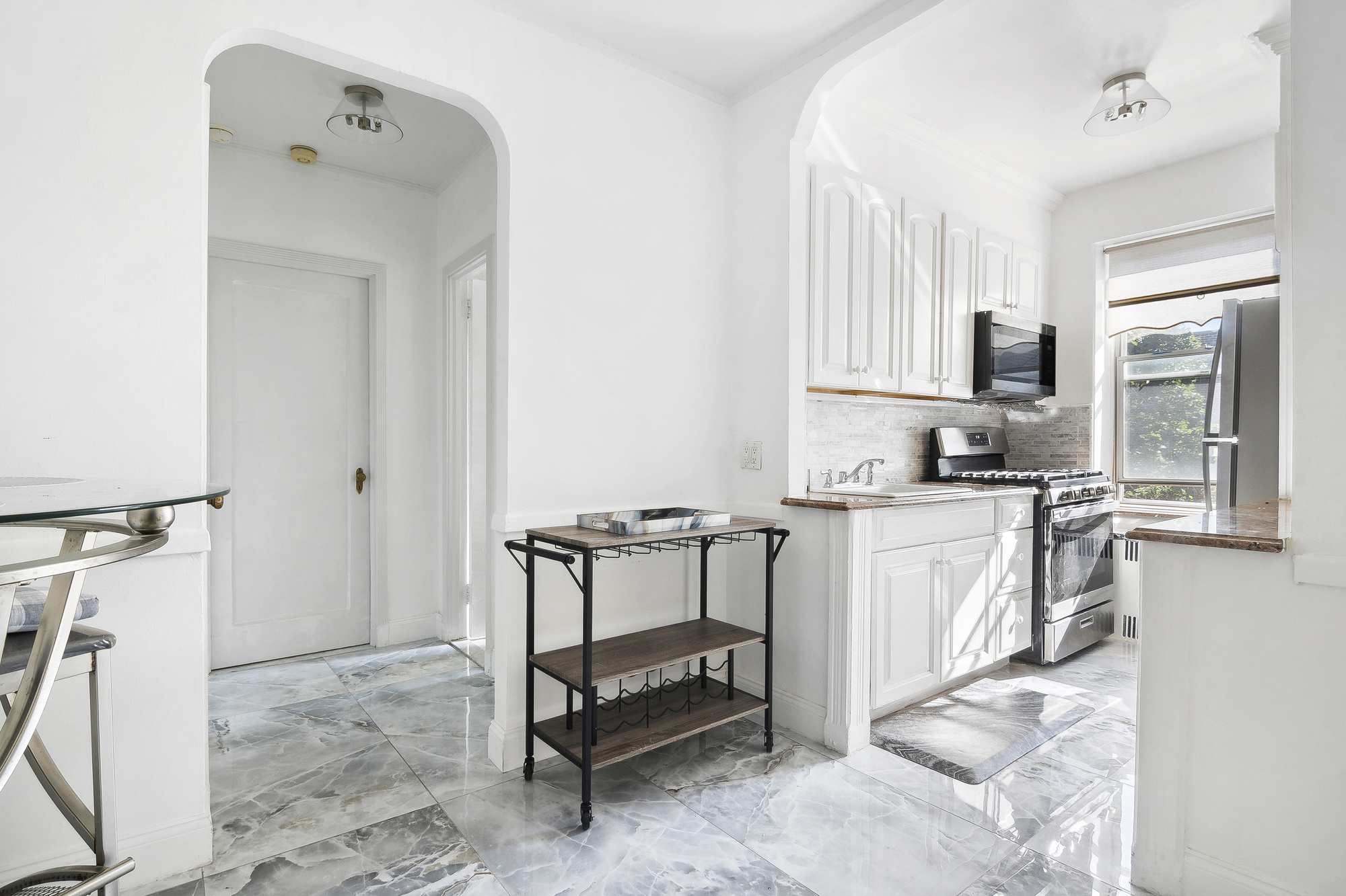 1615 Avenue I, Unit 611 Brooklyn, NY 11230 - Photo 3 of 5 a kitchen with a sink cabinets and window