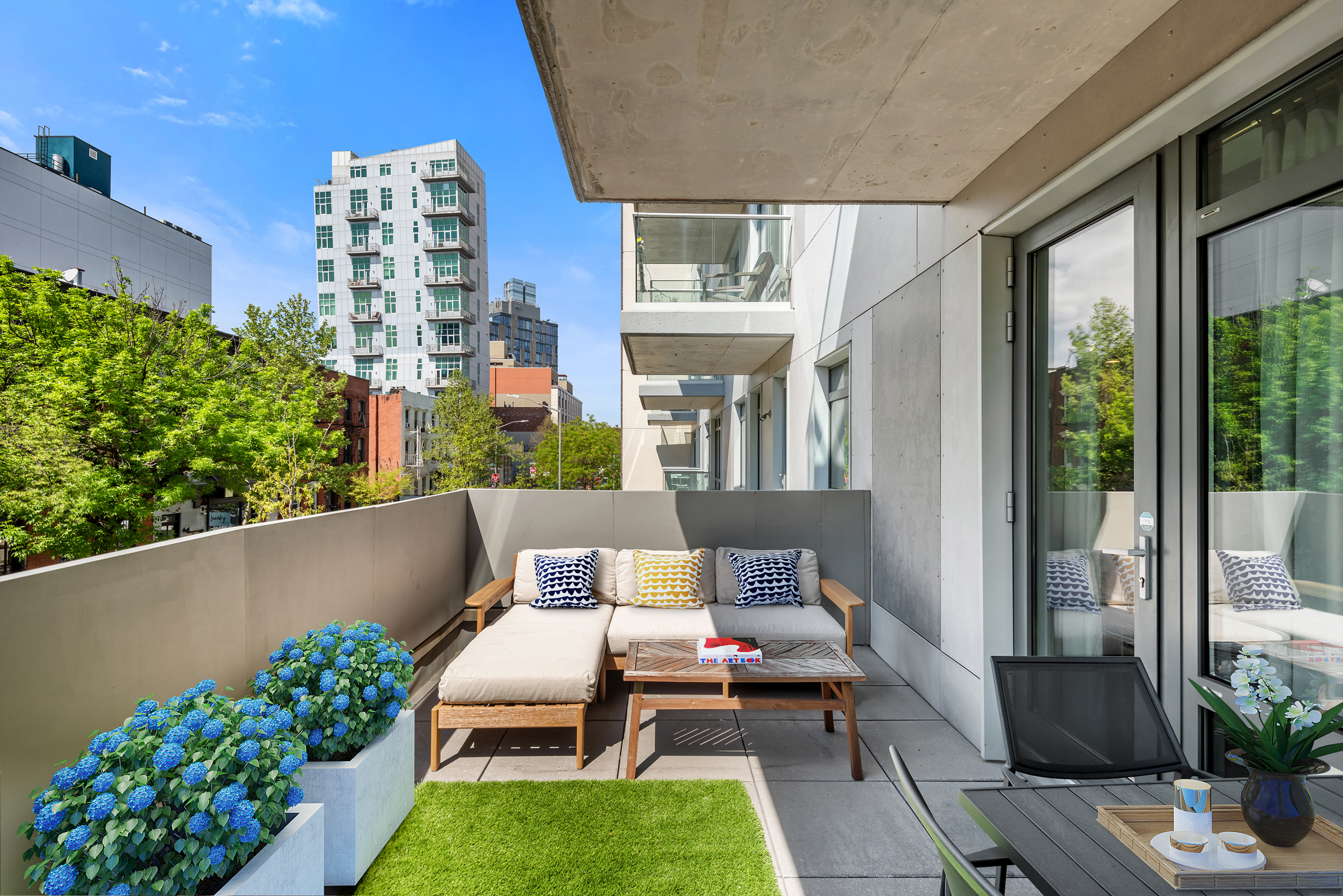 147 Hope Street, Unit 2D Brooklyn, NY 11211 - Photo 8 of 13 a balcony with outdoor seating and plants