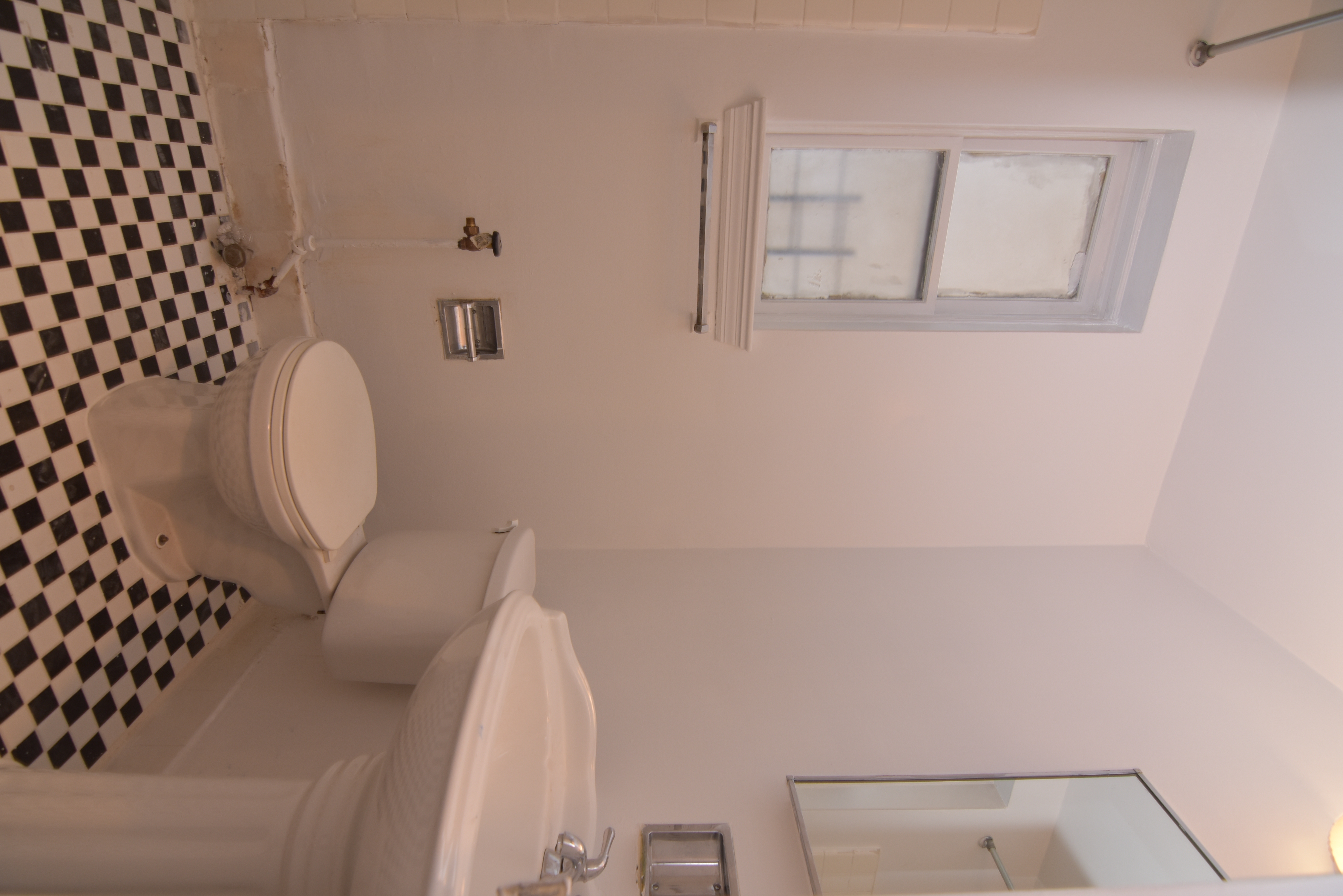 18 East 67th Street, Unit 2B/3B Manhattan, NY 10065 - Photo 6 of 18 a bathroom with a sink a toilet and mirror