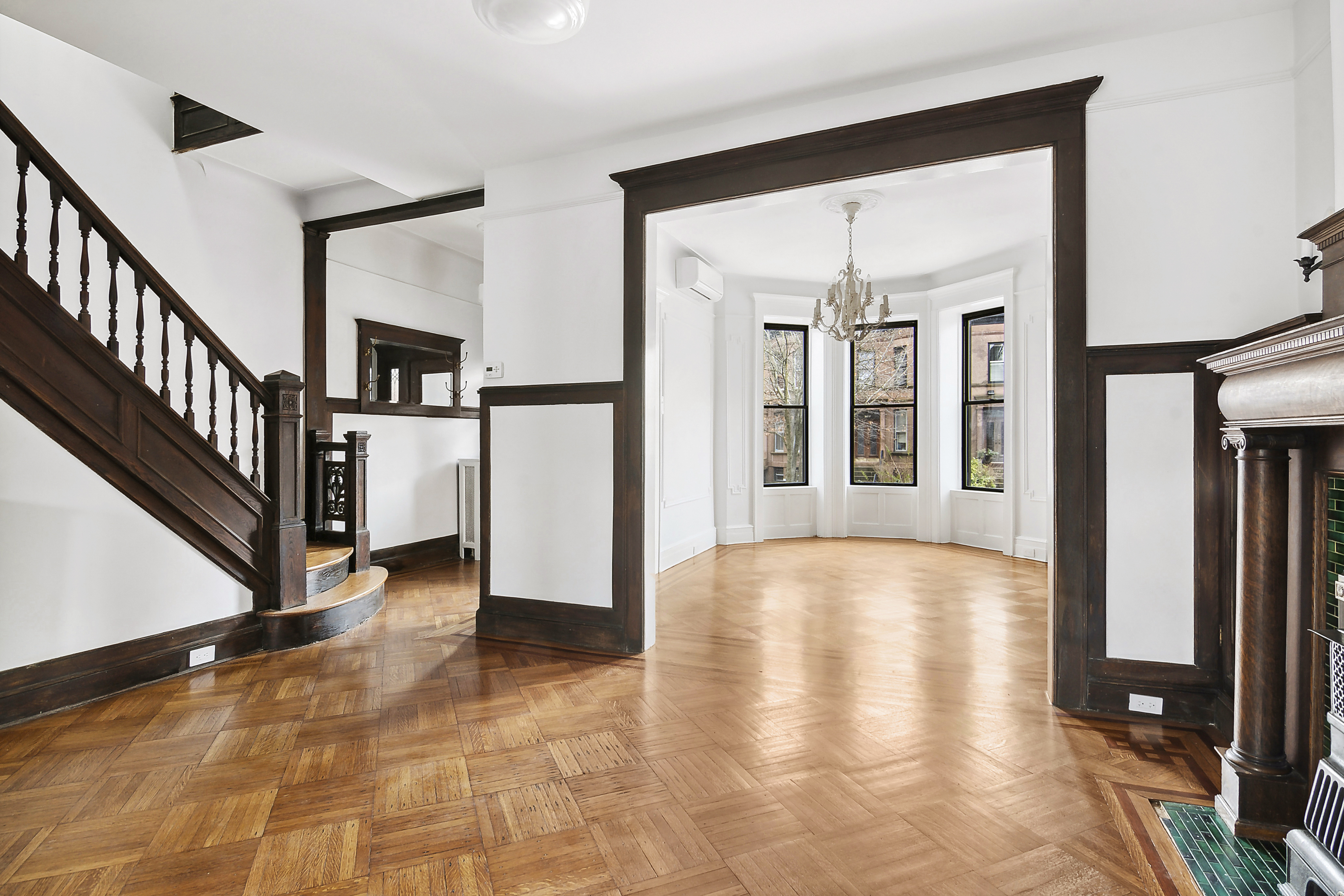 a view of an entryway with wooden floor and door