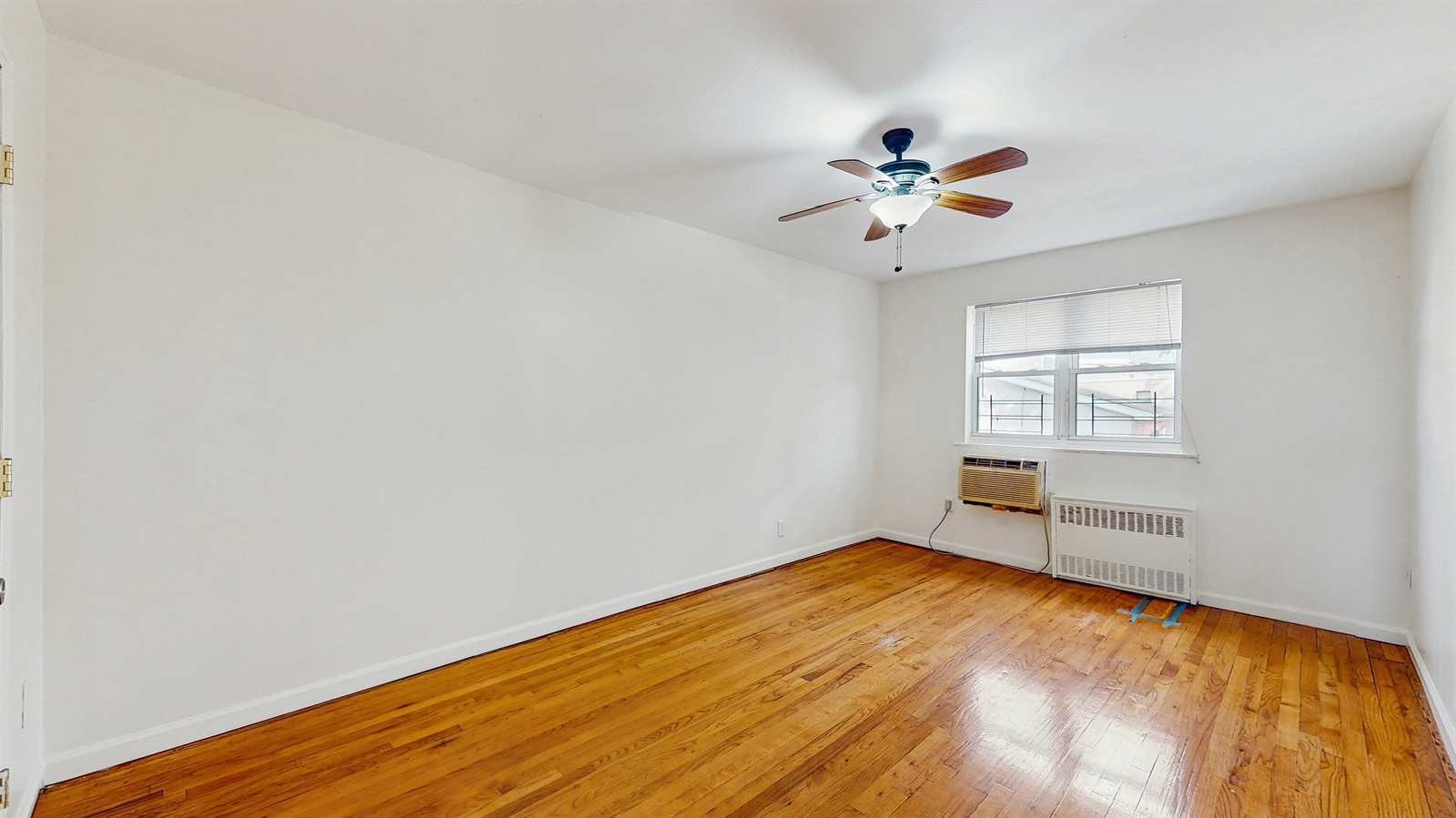 295 Conklin Avenue, Unit 3 Brooklyn, NY 11236 - Photo 8 of 15 wooden floor in an empty room with a window