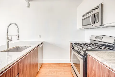 a kitchen with a stove and a sink