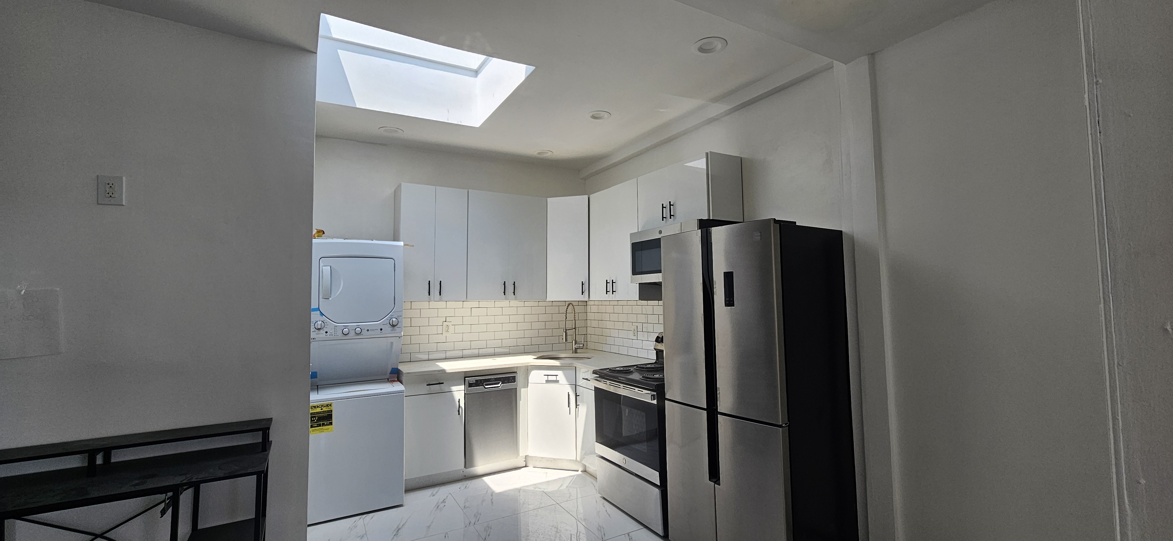 2610 Atlantic Avenue, Unit 3 Brooklyn, NY 11207 - Photo 1 of 5 a kitchen with a refrigerator and white cabinets