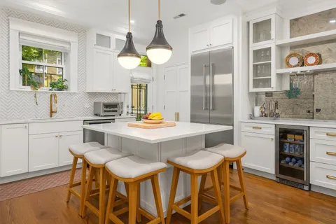 a kitchen with a table chairs sink and cabinets
