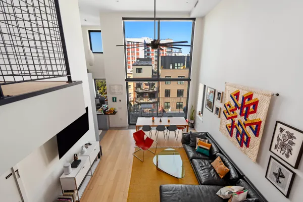 a living room with furniture cabinets and window