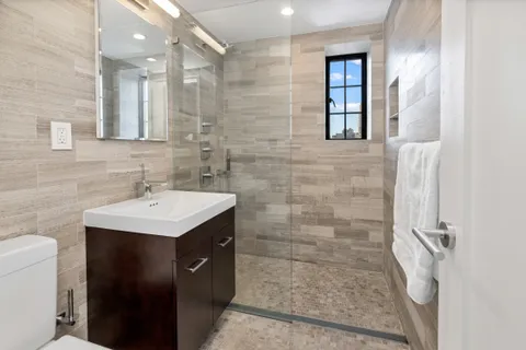 a bathroom with a sink toilet and shower