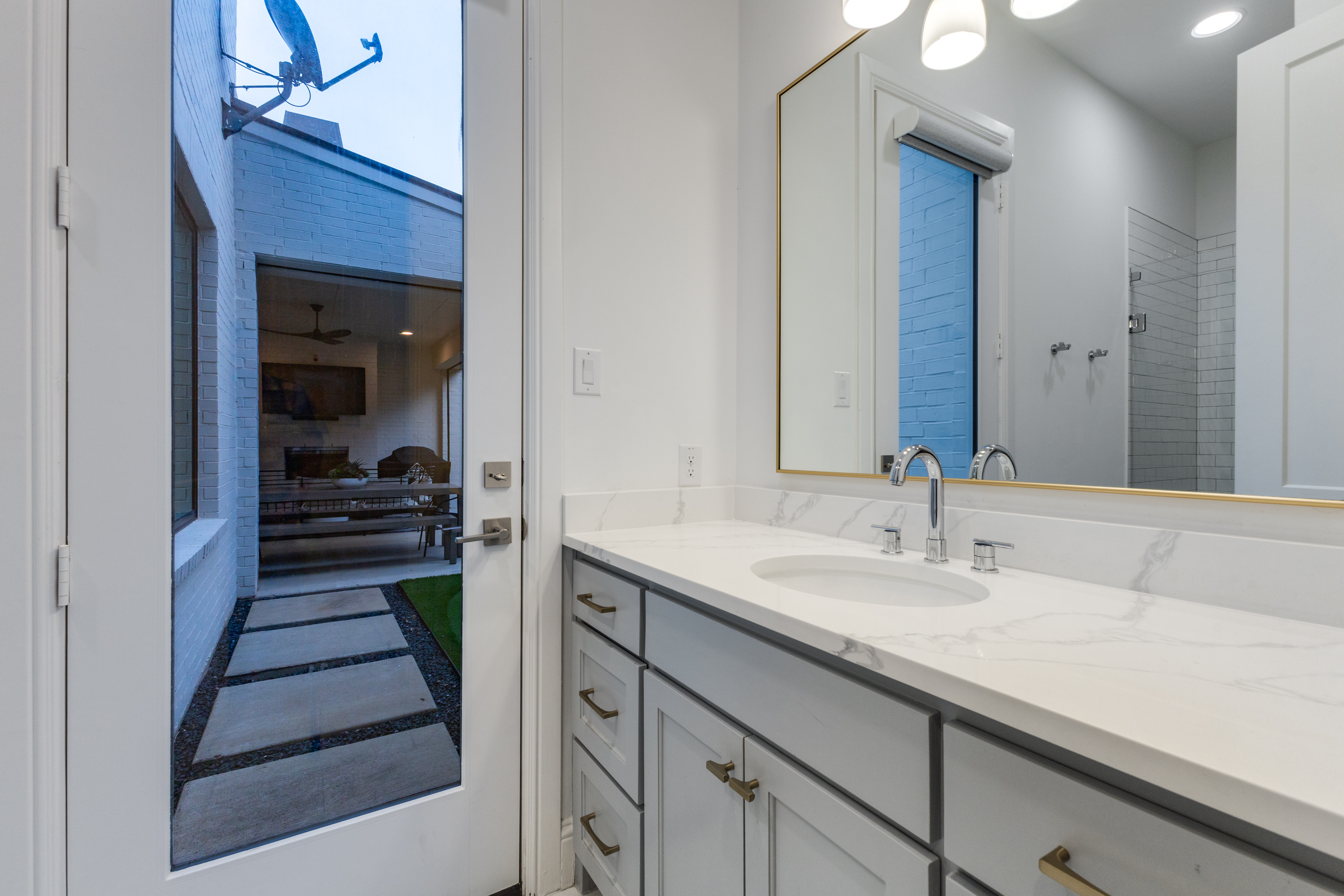 4042 Dunhaven Road Dallas, TX 75220 - Photo 31 of 34 a bathroom with a sink and a mirror
