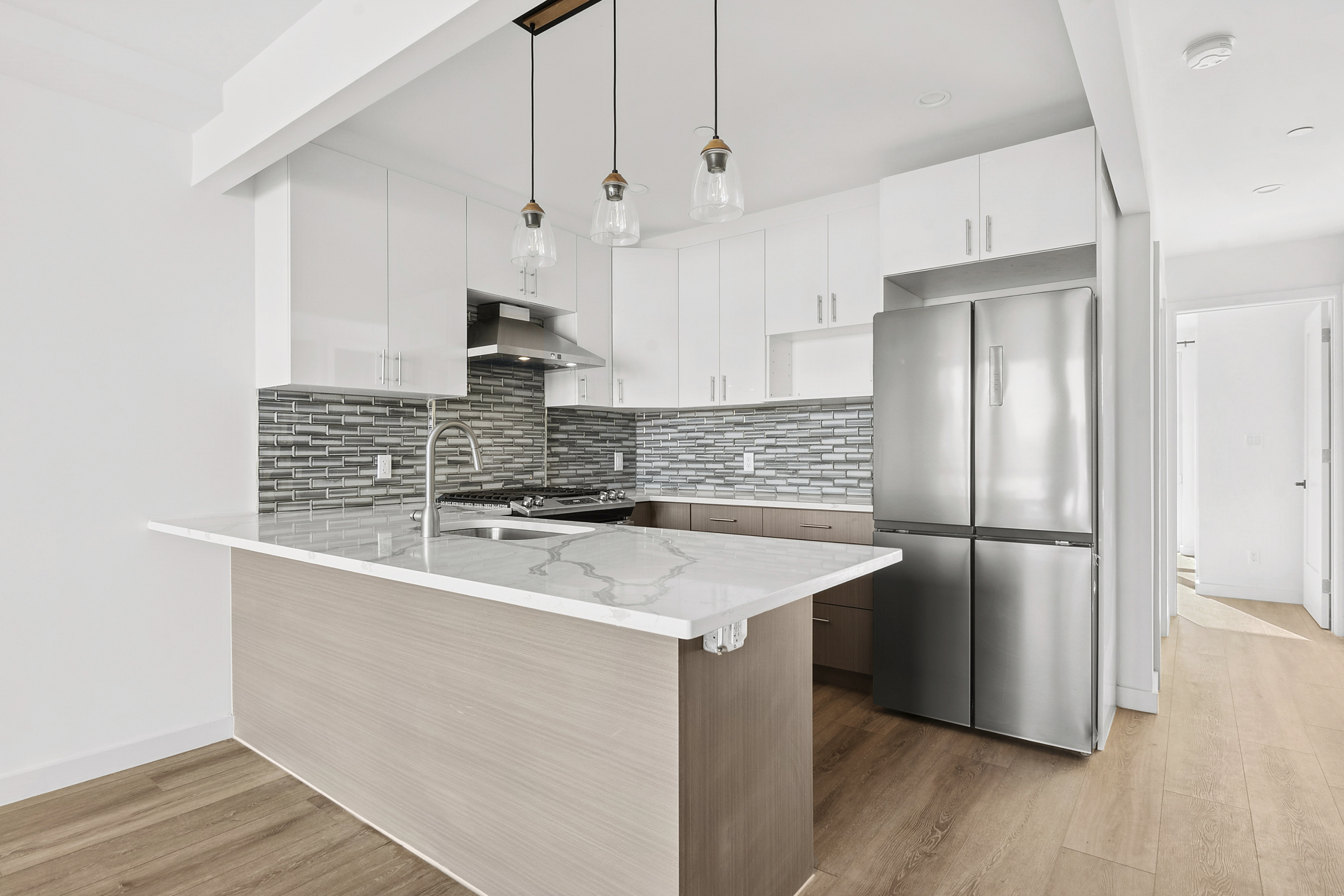 176 12th Street, Unit 3 Brooklyn, NY 11215 - Photo 4 of 11 a kitchen with stainless steel appliances granite countertop a sink a refrigerator a stove and a wooden floors