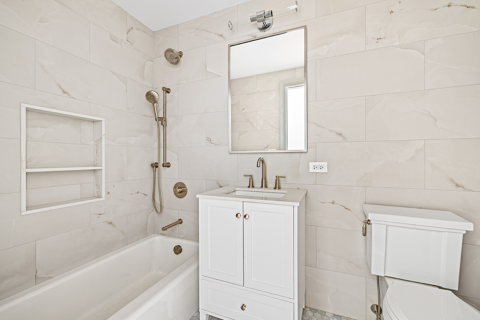 119 Henry Street, Unit 3 Brooklyn, NY 11201 - Photo 12 of 14 a bathroom with a bathtub a mirror a sink and vanity