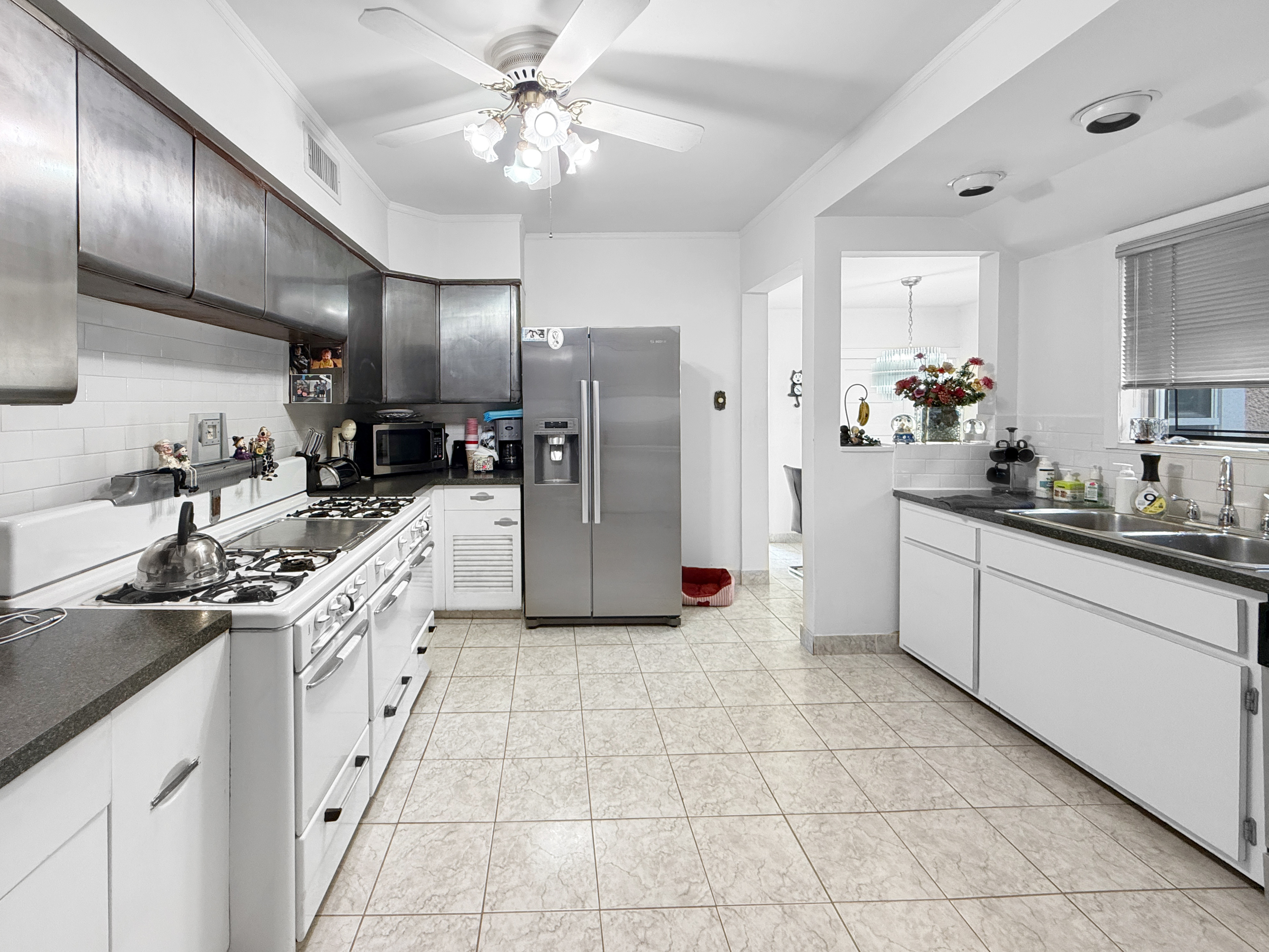3829 Beach 38th Street Brooklyn, NY 11224 - Photo 9 of 31 a kitchen with a sink cabinets and stainless steel appliances