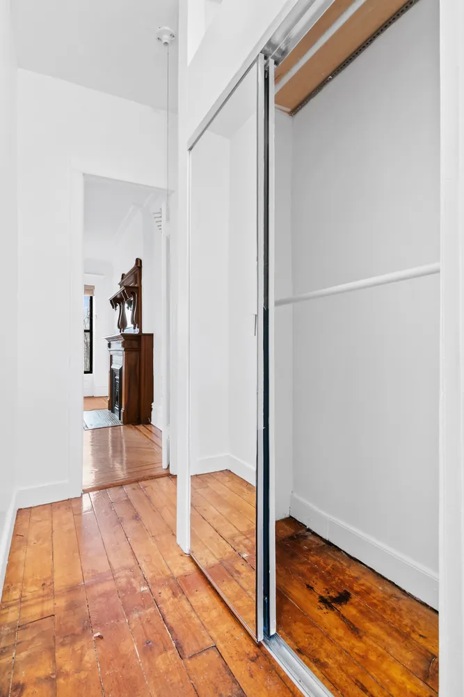 a view of hallway with wooden floor