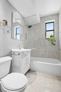 a bathroom with a sink a toilet and bathtub