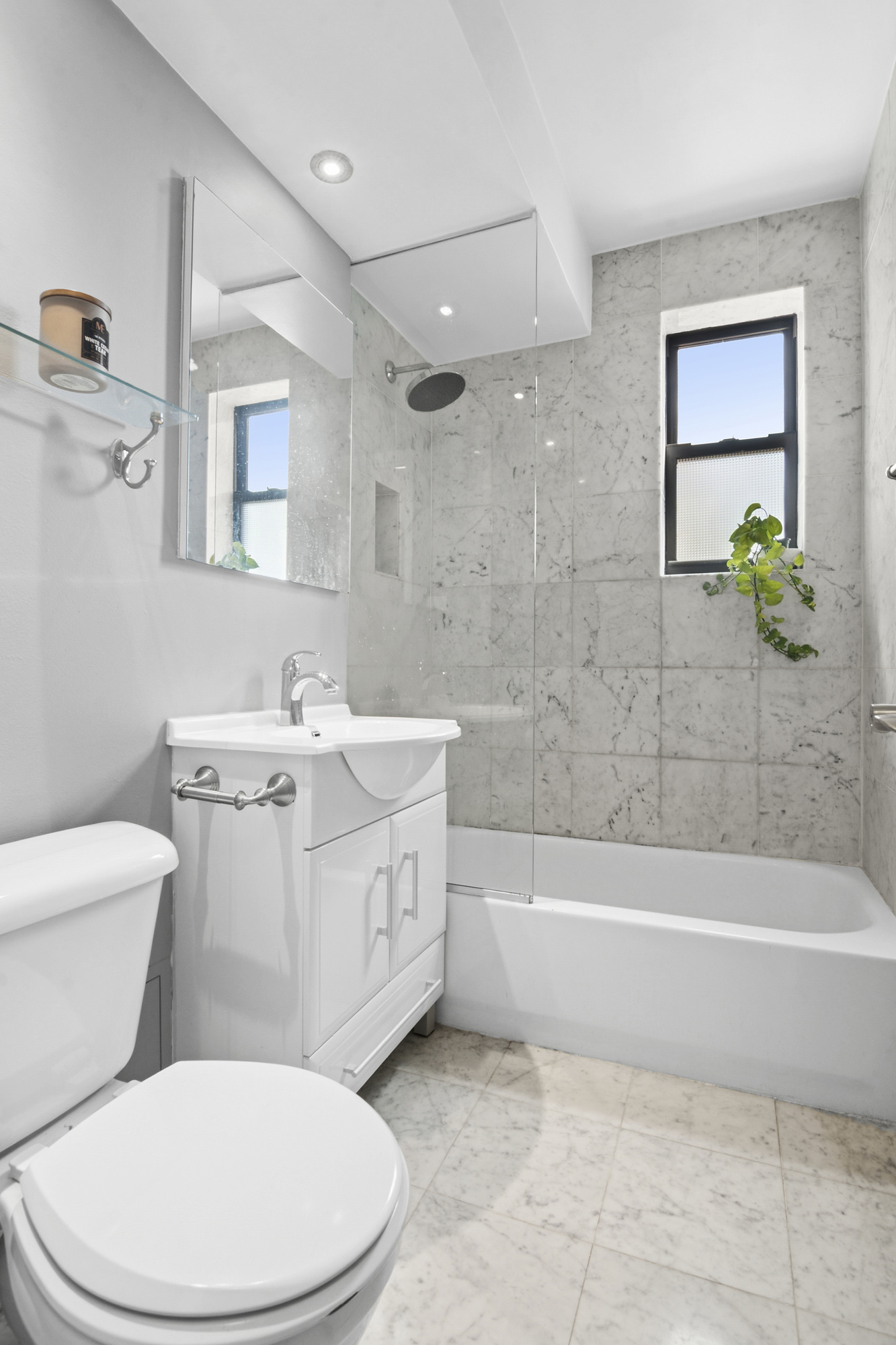 9511 Shore Road, Unit 606 Brooklyn, NY 11209 - Photo 6 of 17 a bathroom with a sink a toilet and bathtub