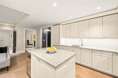 a kitchen with a sink a stove and cabinets