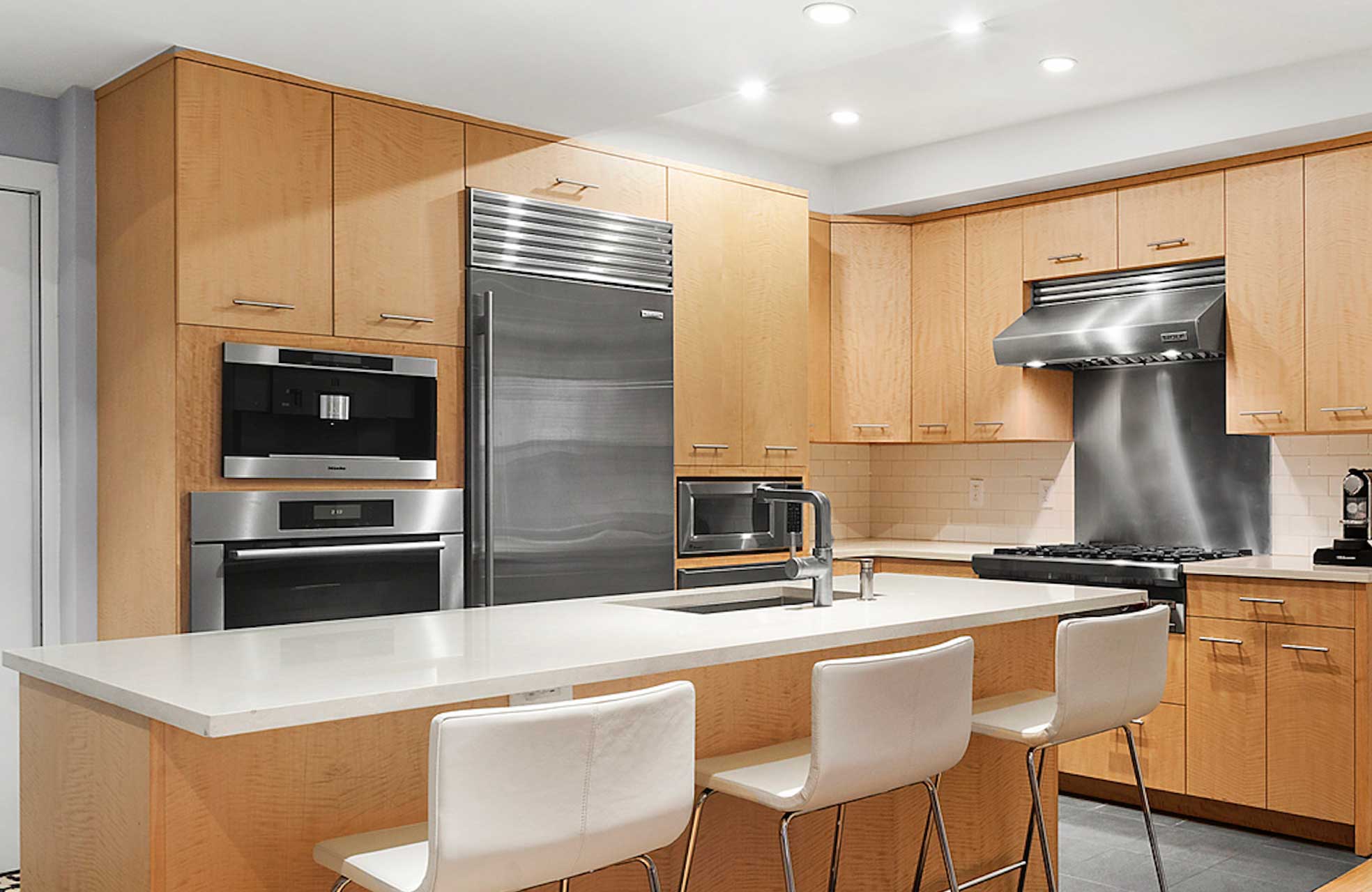 210 West 19th Street, Unit 1G Manhattan, NY 10011 - Photo 2 of 13 a kitchen with kitchen island a sink stove and refrigerator