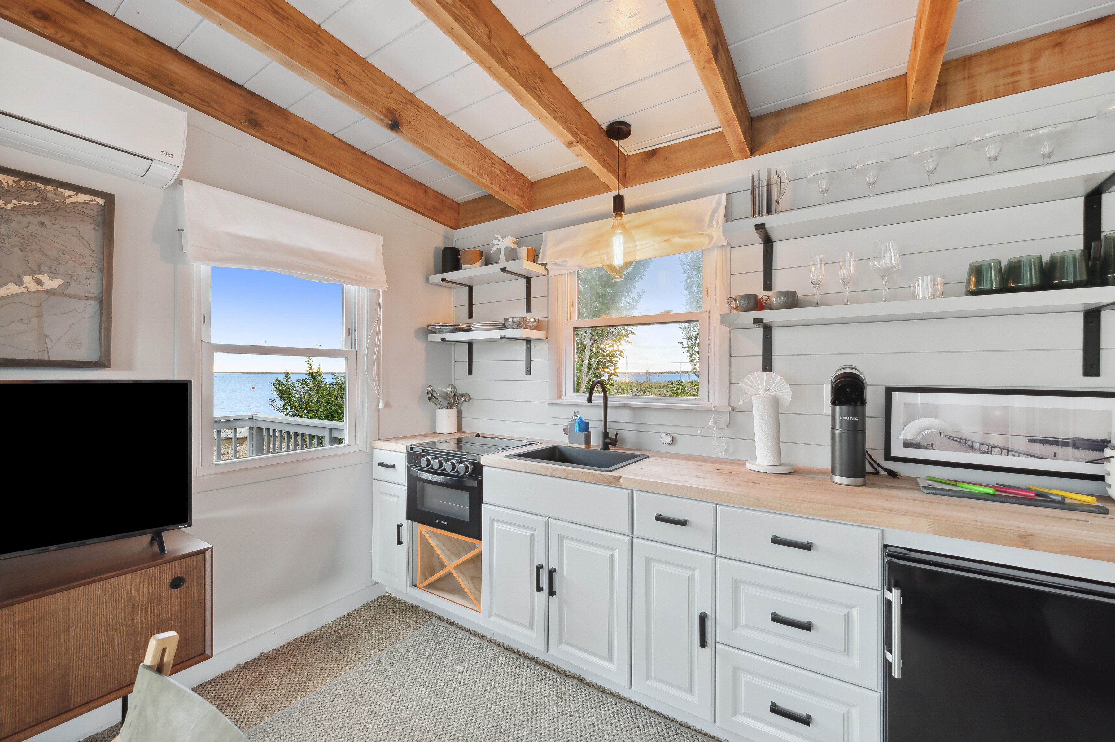32 Lighthouse Road Hampton Bays, NY 11946 - Photo 41 of 51 a kitchen with granite countertop a sink stainless steel appliances and cabinets