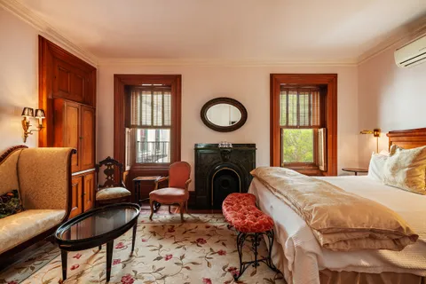 a bedroom with a bed and a fireplace