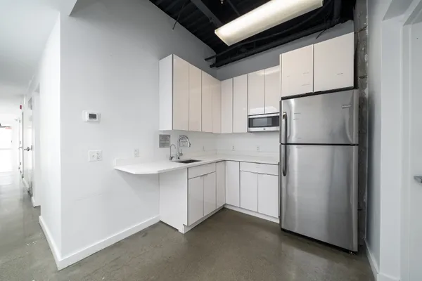 a kitchen with stainless steel appliances a refrigerator sink and cabinets