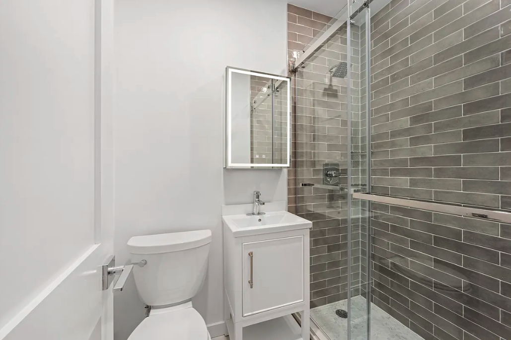 62 West 87th Street, Unit 1F Manhattan, NY 10024 - Photo 5 of 6 a bathroom with a sink toilet and shower