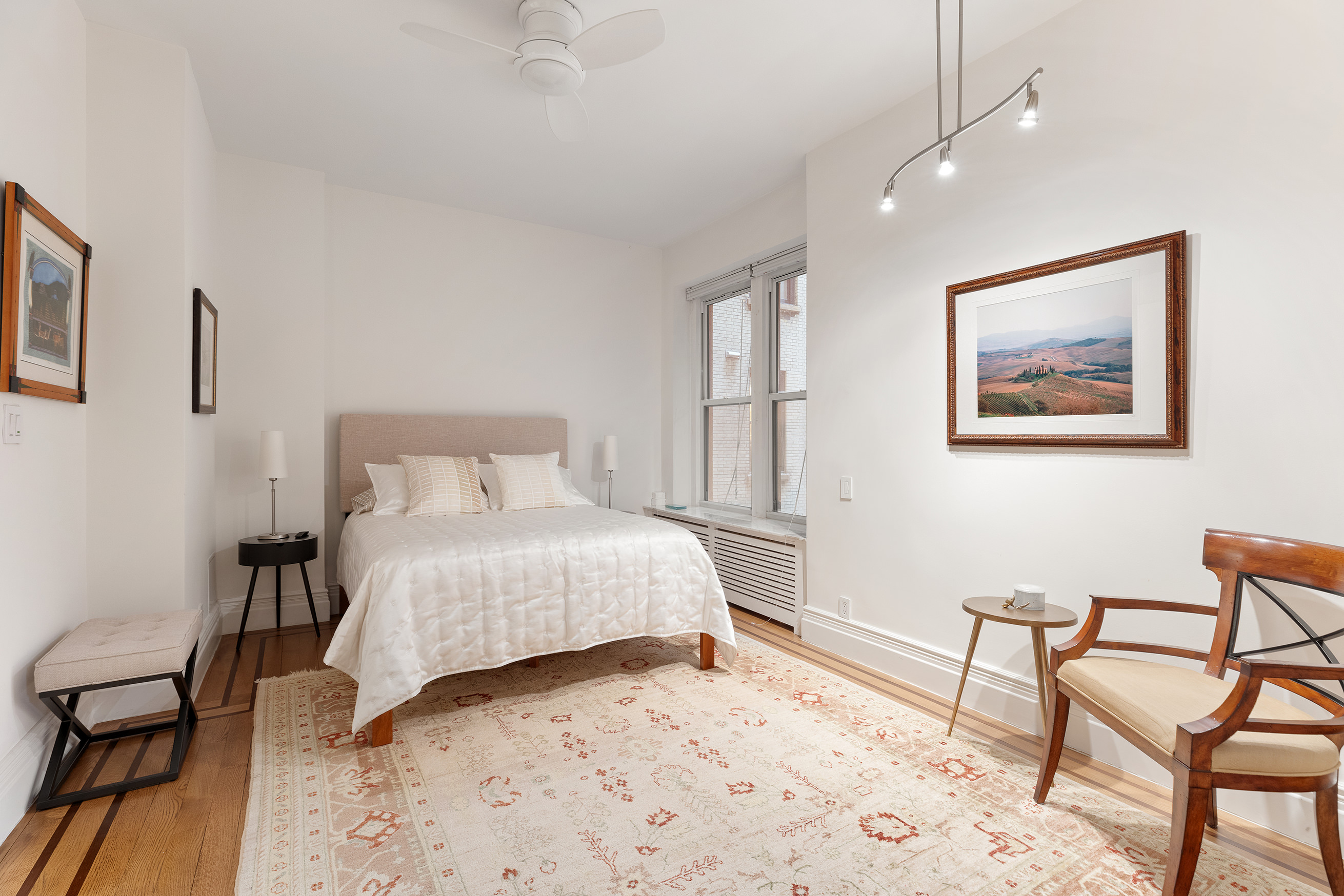 137 Riverside Drive, Unit 2D Manhattan, NY 10024 - Photo 6 of 20 a bedroom with a bed and a table in it