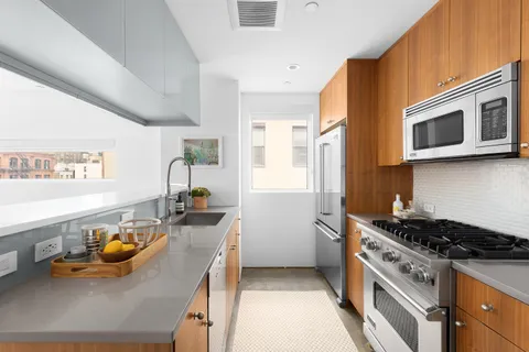 a kitchen with stainless steel appliances granite countertop a stove and a sink