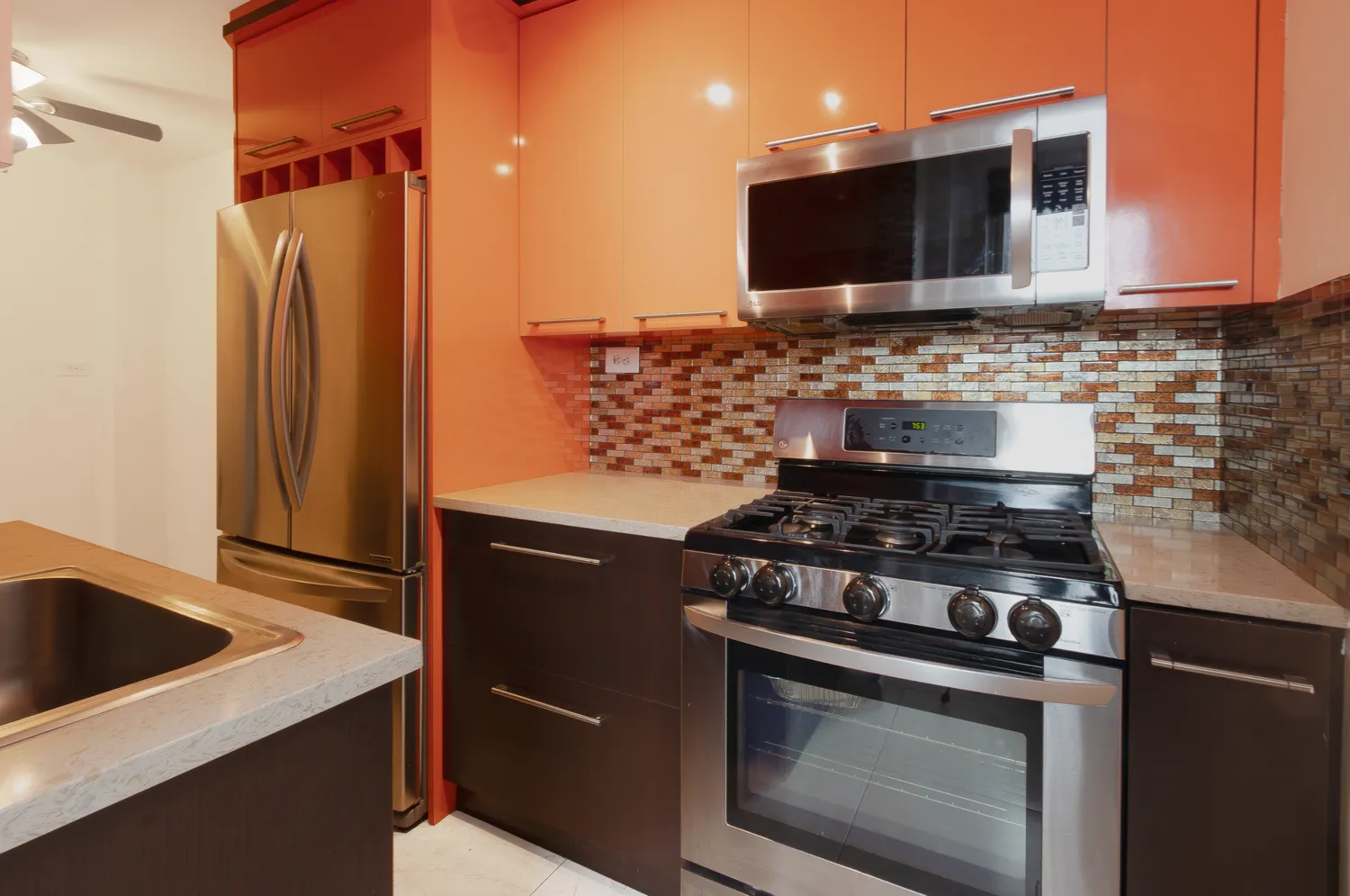 a kitchen with stainless steel appliances granite countertop a stove and a refrigerator