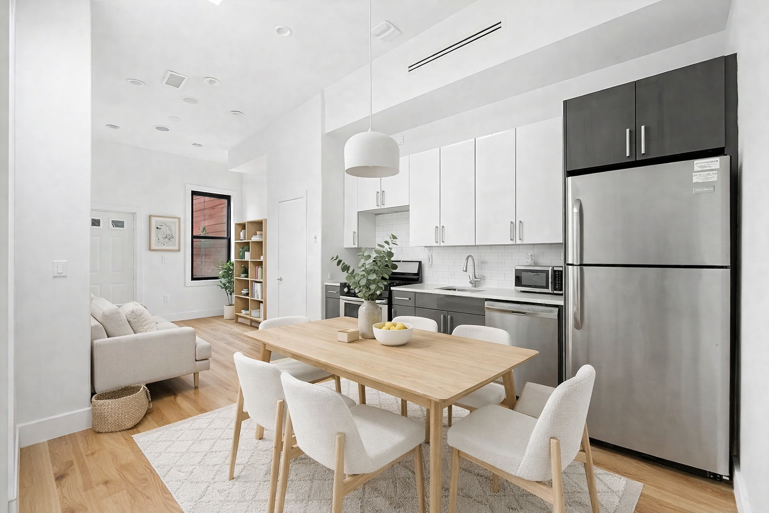 a kitchen with stainless steel appliances a dining table chairs and refrigerator