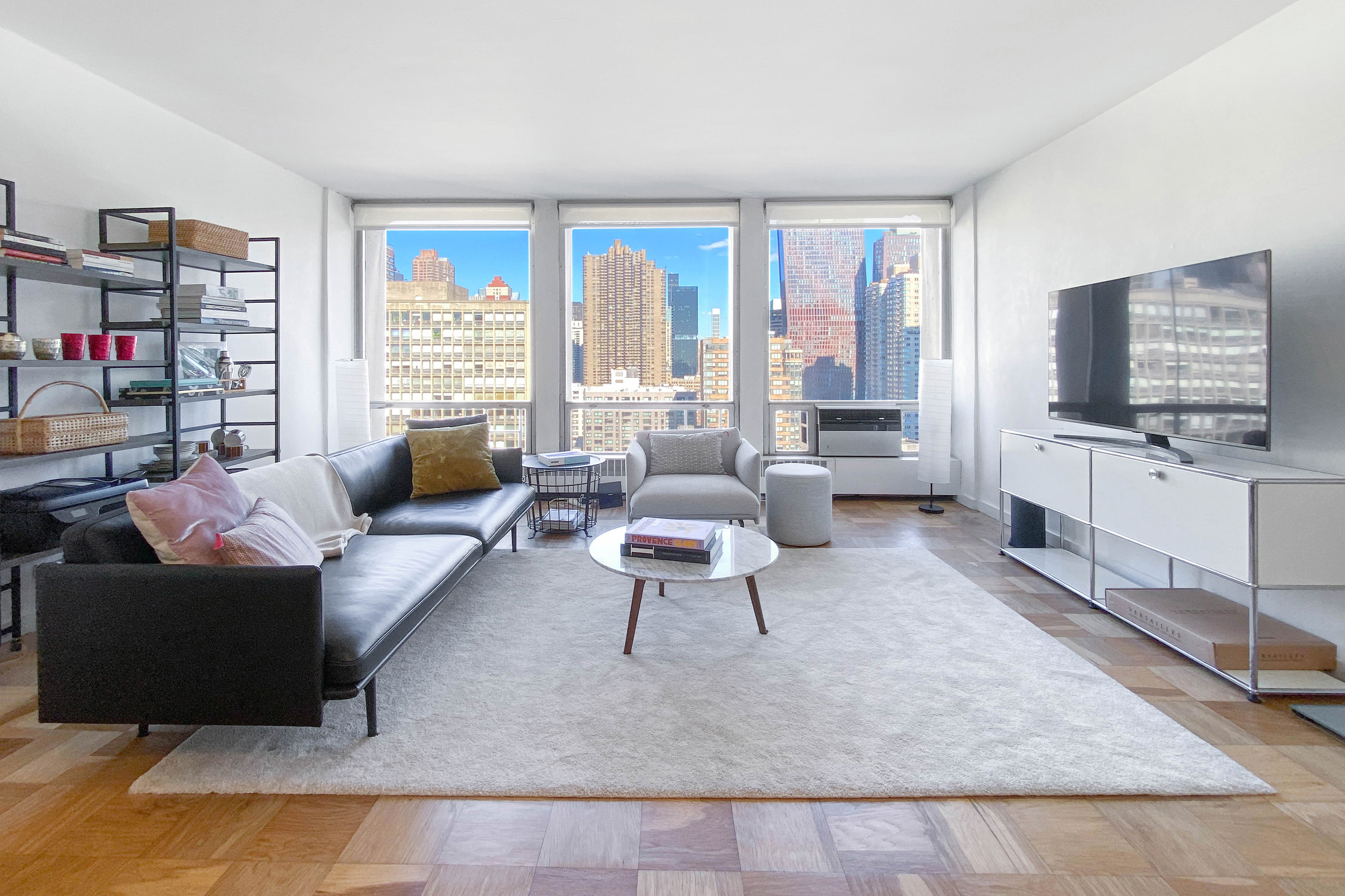 343 East 30th Street, Unit 18A Manhattan, NY 10016 - Photo 1 of 17 a living room with furniture and a flat screen tv