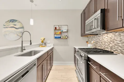 a kitchen with a sink stove and microwave