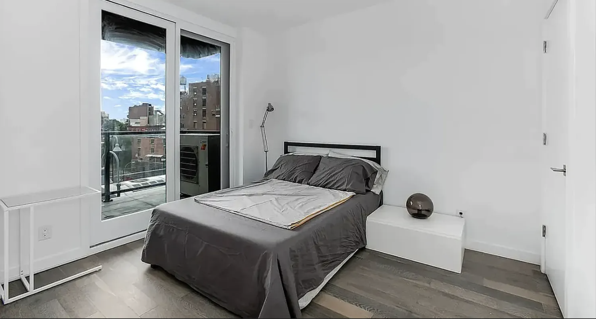 319 Broadway, Unit PHA Brooklyn, NY 11211 - Photo 4 of 6 a bedroom with a bed and a window