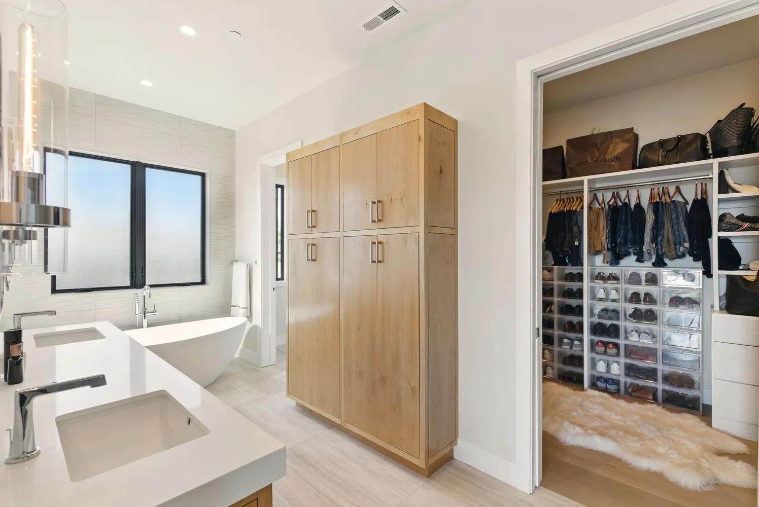 a bathroom with a double vanity sink mirror and shower