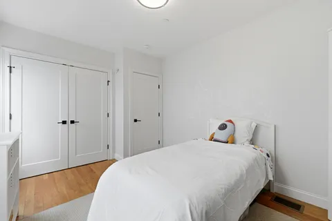 a bedroom with a bed and a closet