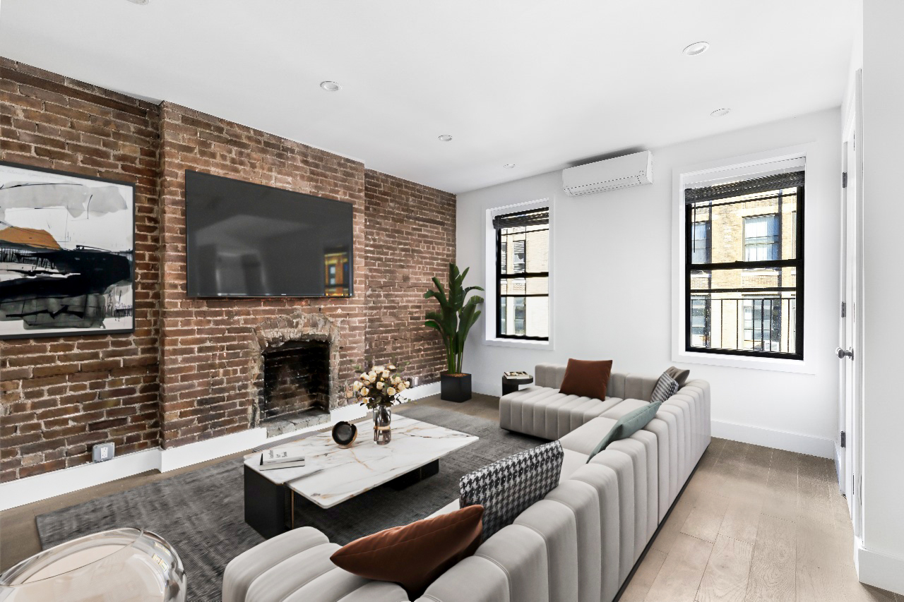 346 West 52nd Street, Unit 5D Manhattan, NY 10019 - Photo 1 of 7 a living room with furniture flat screen tv and a fireplace