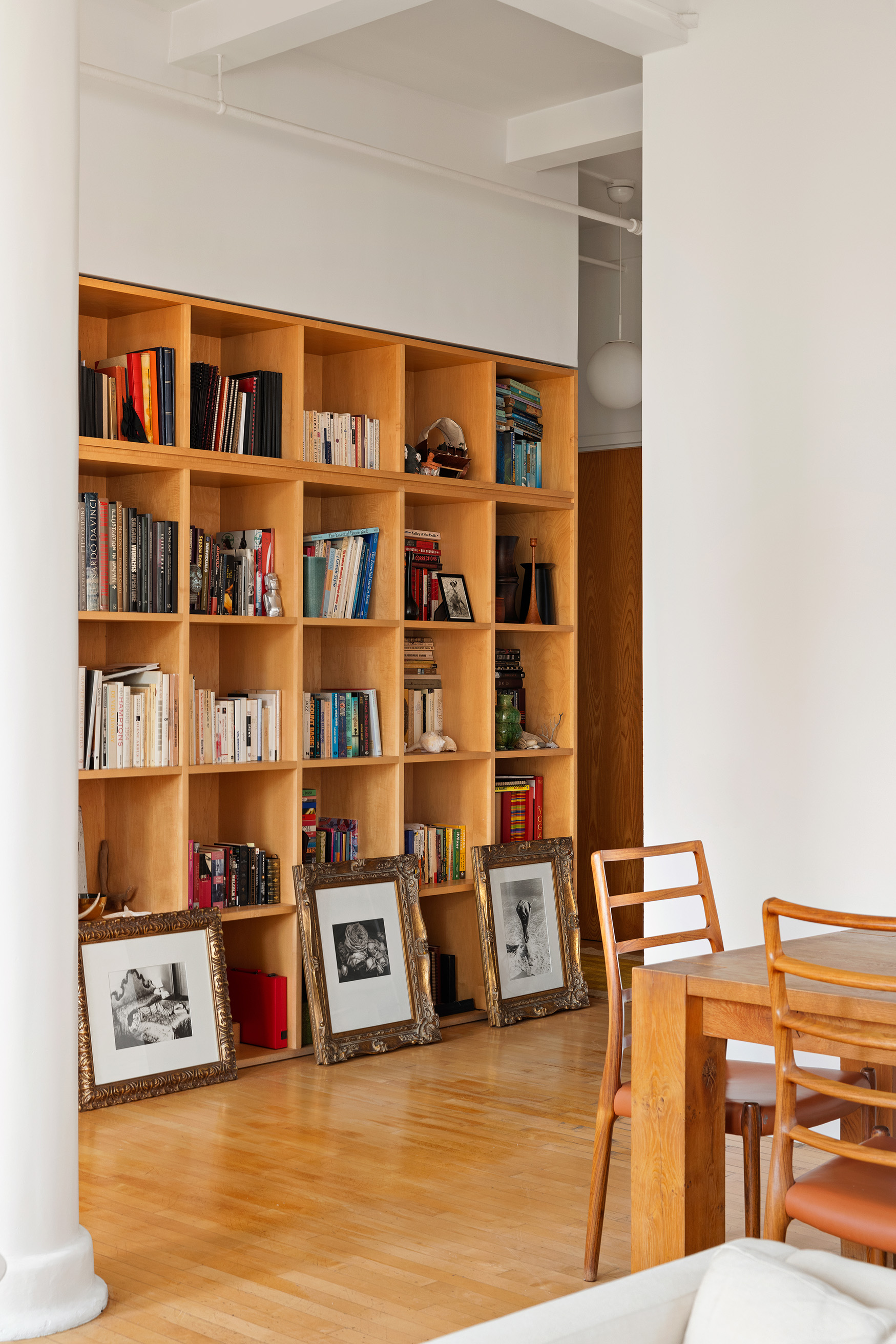 32 West 20th Street, Unit 9B Manhattan, NY 10011 - Photo 12 of 16 a living room with lots of books and a book shelf