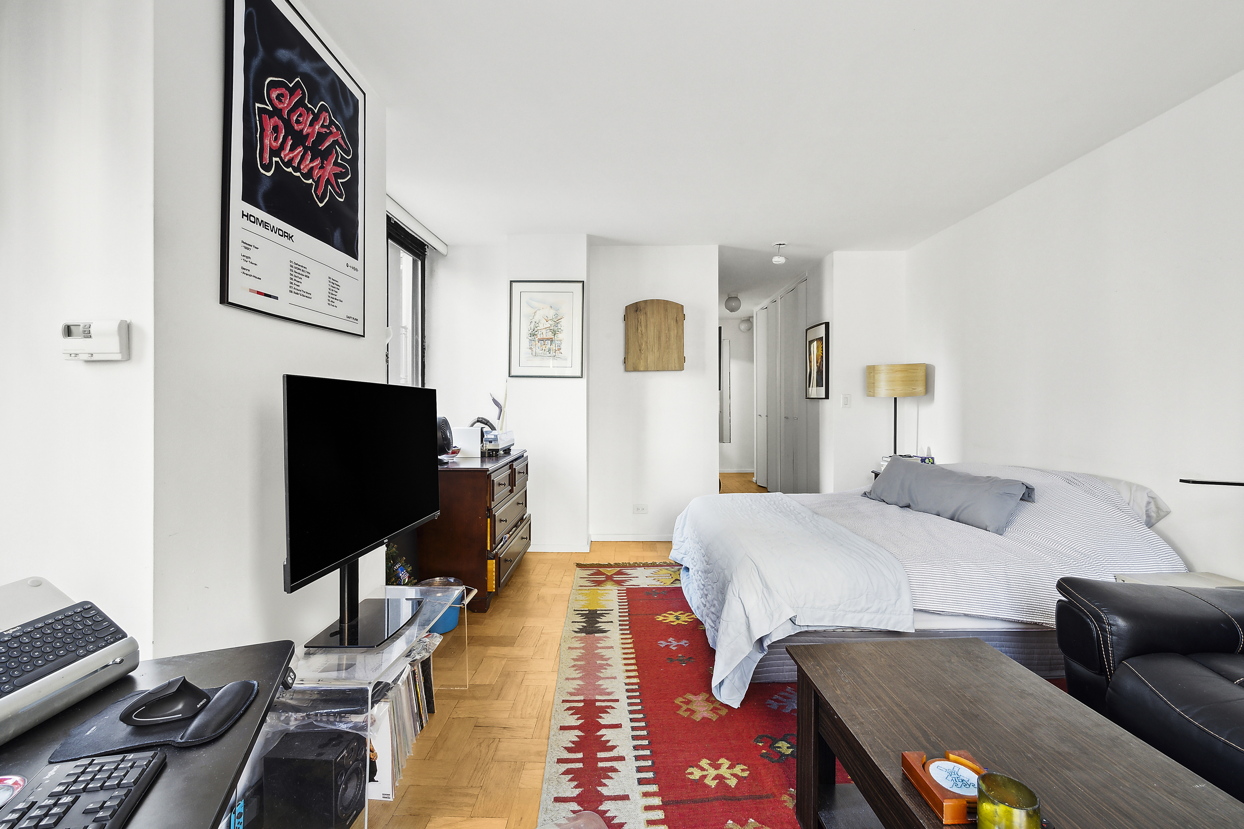 455 East 86th Street, Unit 5E Manhattan, NY 10028 - Photo 2 of 5 a bedroom with a bed and a flat screen tv