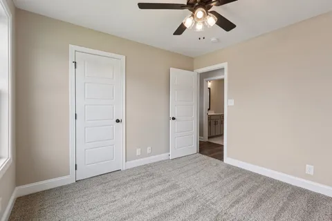 a view of an empty room with a ceiling fan