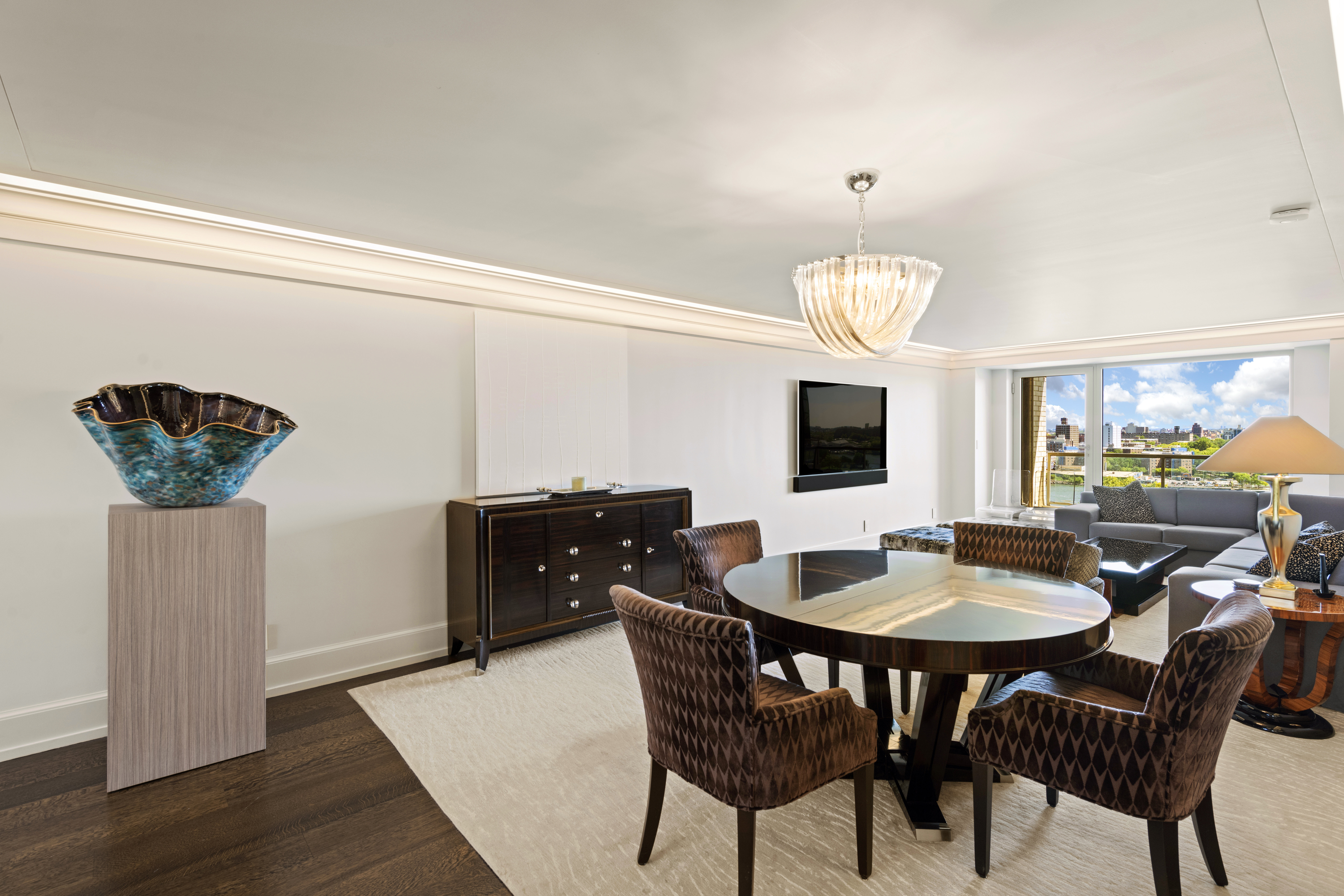 180 East End Avenue, Unit 15E Manhattan, NY 10128 - Photo 3 of 31 a dining room with furniture a chandelier and wooden floor