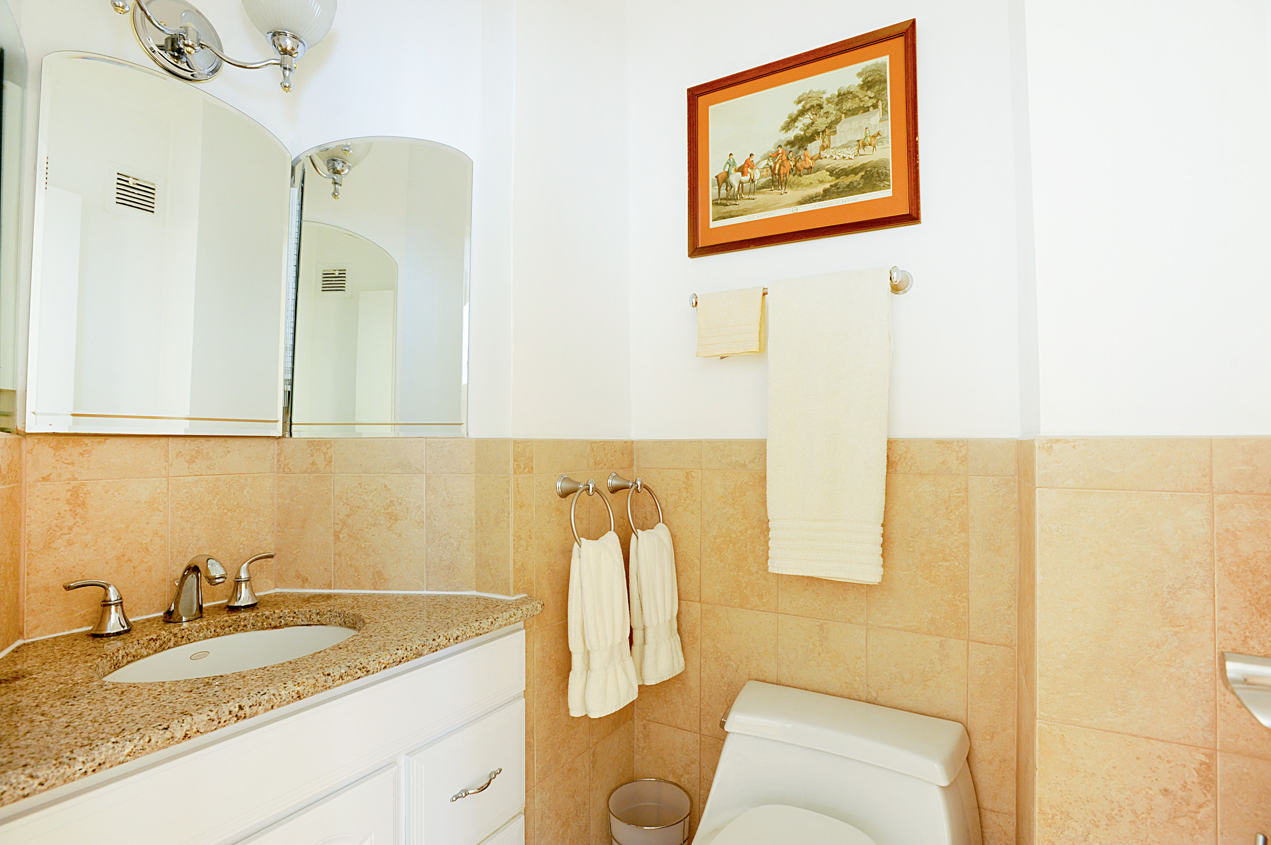 159 West 53rd Street, Unit 18B Manhattan, NY 10019 - Photo 8 of 11 a bathroom with a granite countertop sink and a mirror