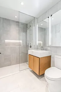 a bathroom with a tub sink mirror and toilet