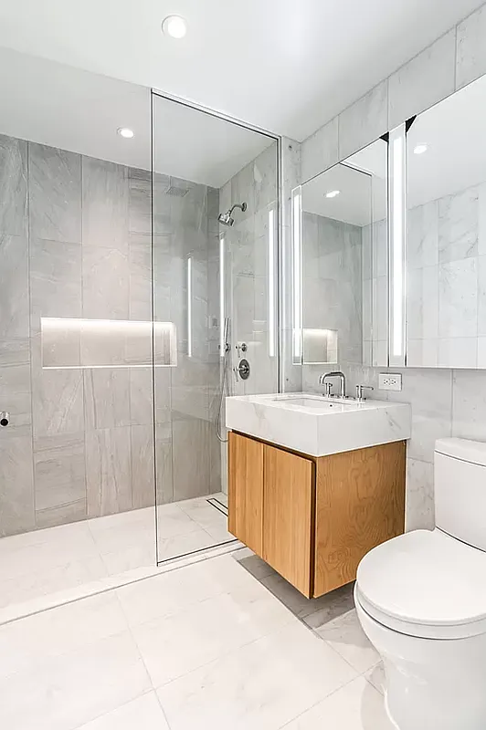 300 West 30th Street, Unit 6A Manhattan, NY 10001 - Photo 6 of 13 a bathroom with a tub sink mirror and toilet