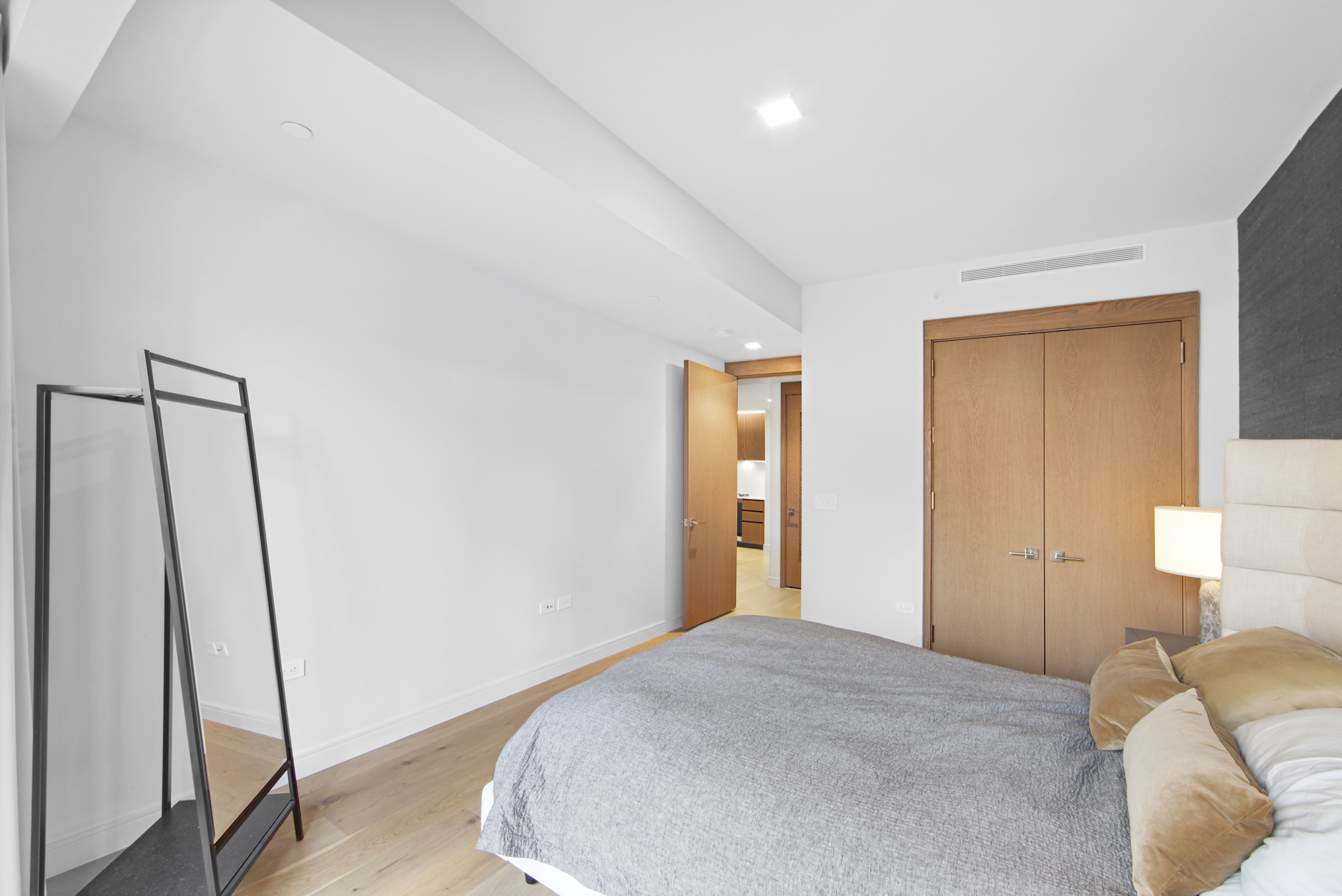 200 East 21st Street, Unit 4B Manhattan, NY 10010 - Photo 11 of 15 a bedroom with a bed and a mirror