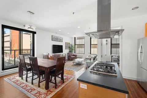 a large kitchen with a table and chairs