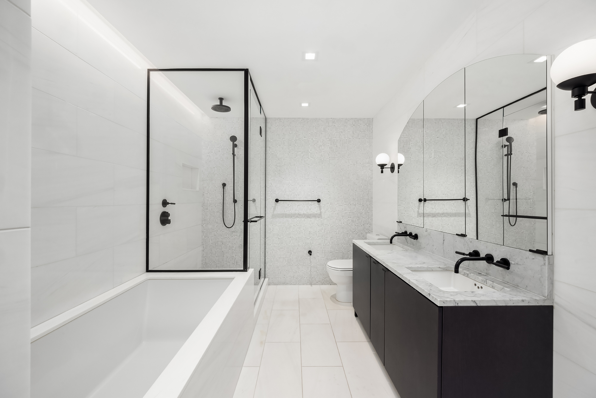 55 West 17th Street, Unit 603 Manhattan, NY 10011 - Photo 6 of 9 a bathroom with a tub sink shower and mirror