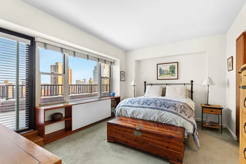 a bedroom with a bed and a balcony