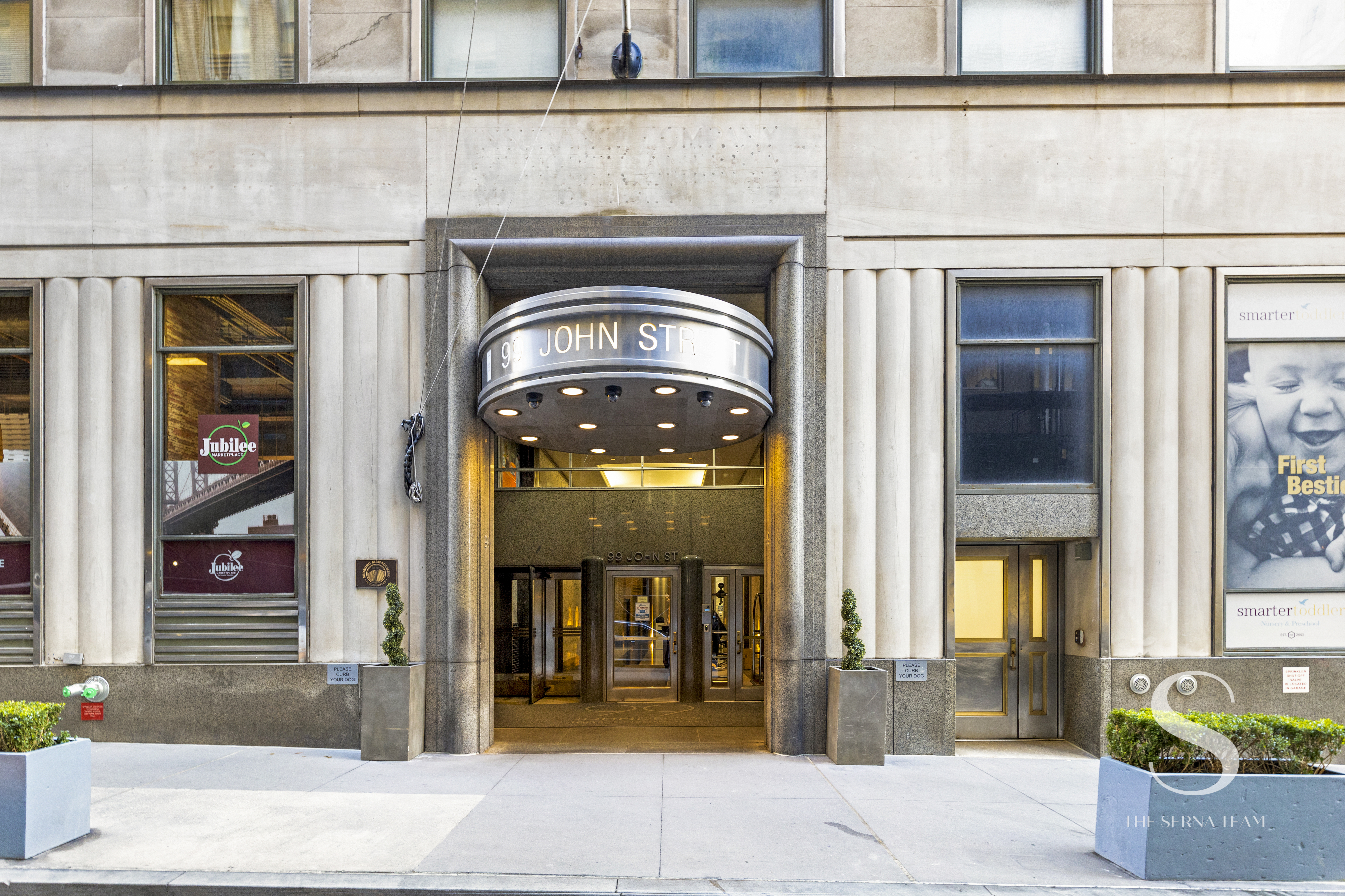99 John Street, Unit 910 Manhattan, NY 10038 - Photo 7 of 11 a front view of a building with retail shops