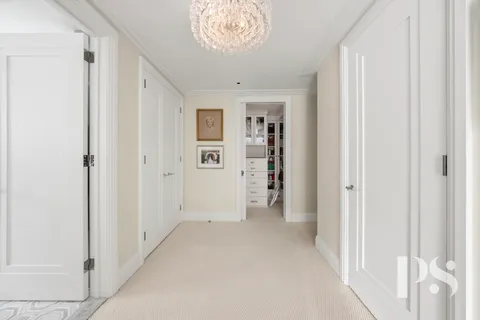 a view of empty room with a window and a kitchen